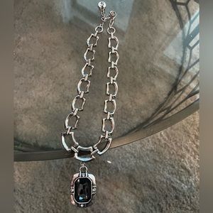 Silver link chain with a black tinted gem. Great condition.